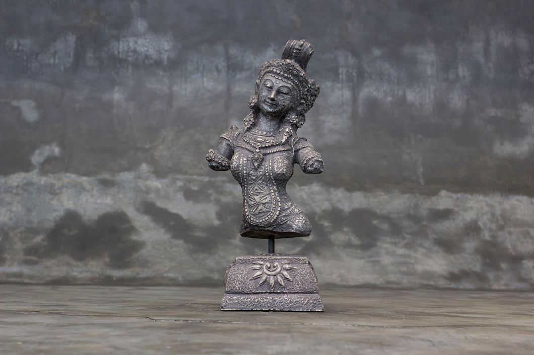 Decorative cement relief on a stand with Hindu goddess Dewi Sri carving.