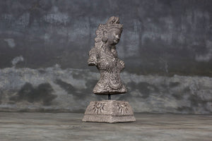 Decorative cement relief on a stand with Hindu goddess Dewi Sri carving.